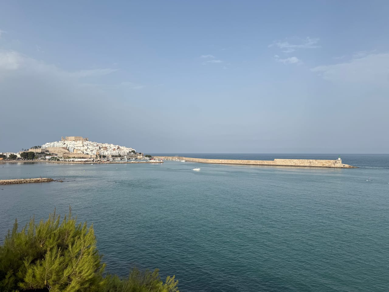 Vista panorámica del castillo de Peñíscola y la bahía en calma, con el mar Mediterráneo dominando la imagen